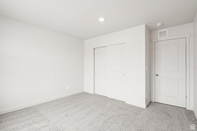 3537 S 3150 W Unit 106, West Haven, UT 84401 - unfurnished bedroom with baseboards, a closet, light colored carpet, and visible vents