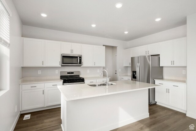 3537 S 3150 W Unit 106, West Haven, UT 84401 - kitchen featuring a sink, white cabinetry, stainless steel appliances, a kitchen island with sink, and dark wood-type flooring