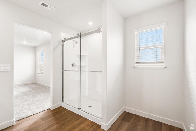 3537 S 3150 W Unit 106, West Haven, UT 84401 - full bathroom featuring a shower stall, baseboards, visible vents, and wood finished floors
