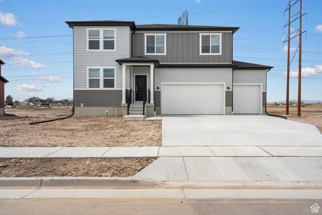 3537 S 3150 W Unit 106, West Haven, UT 84401 - view of front of house featuring a garage, board and batten siding, and concrete driveway