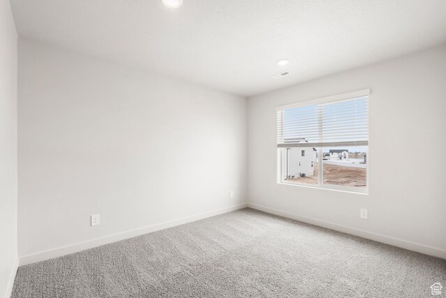 3537 S 3150 W Unit 106, West Haven, UT 84401 - spare room featuring baseboards, visible vents, and carpet