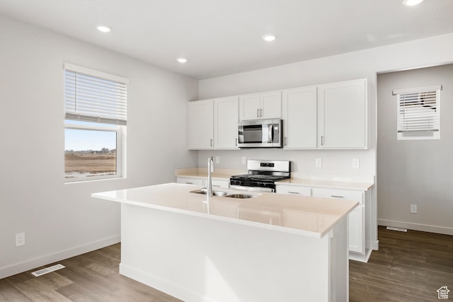 3537 S 3150 W Unit 106, West Haven, UT 84401 - kitchen featuring stainless steel appliances, baseboards, a center island with sink, a sink, and wood finished floors