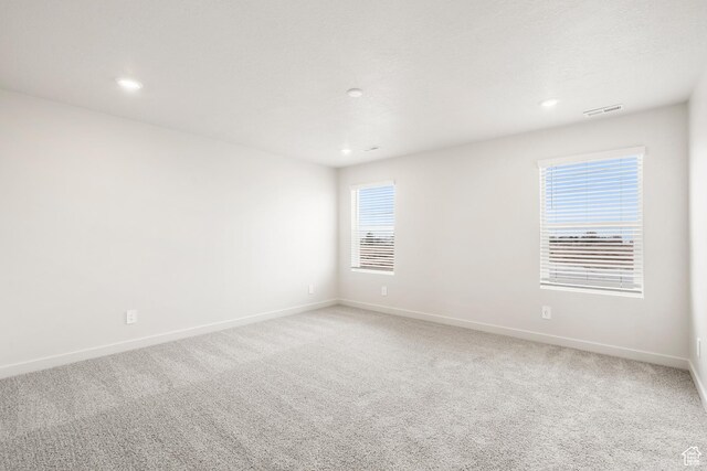 3537 S 3150 W Unit 106, West Haven, UT 84401 - empty room featuring light colored carpet, visible vents, recessed lighting, and baseboards