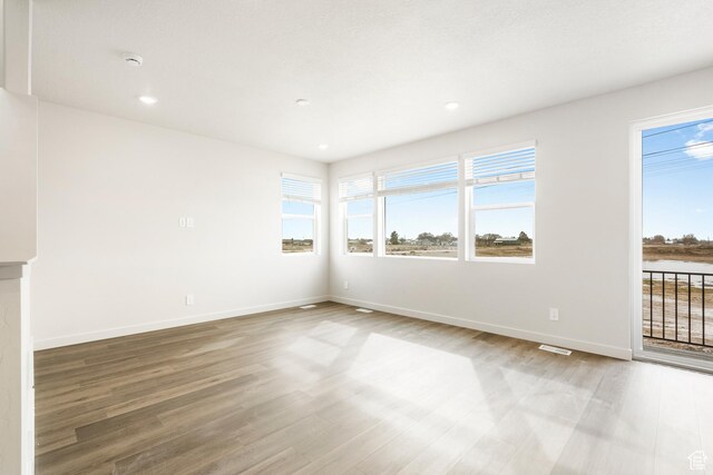 3537 S 3150 W Unit 106, West Haven, UT 84401 - unfurnished room with baseboards, wood finished floors, and a healthy amount of sunlight
