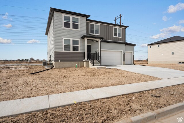 3537 S 3150 W Unit 106, West Haven, UT 84401 - traditional-style house featuring board and batten siding, central AC unit, concrete driveway, and a garage