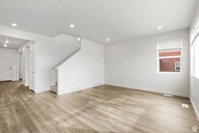 3537 S 3150 W Unit 106, West Haven, UT 84401 - unfurnished living room featuring stairs, visible vents, light wood-style flooring, and recessed lighting