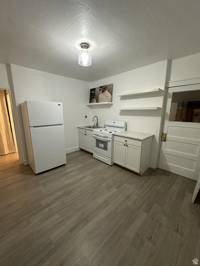 kitchen with white appliances, open shelves, a sink, dark wood-type flooring, and a textured ceiling