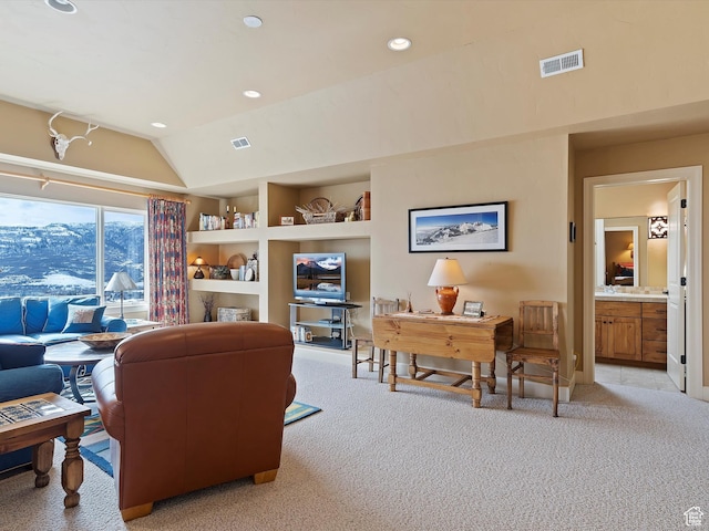 living area featuring light colored carpet, visible vents, vaulted ceiling, and recessed lighting