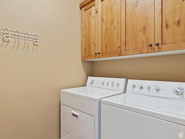 laundry area with cabinet space and washer and clothes dryer