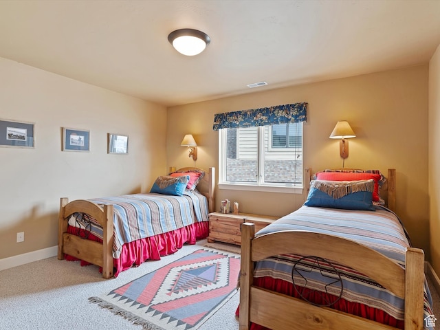 carpeted bedroom featuring visible vents and baseboards
