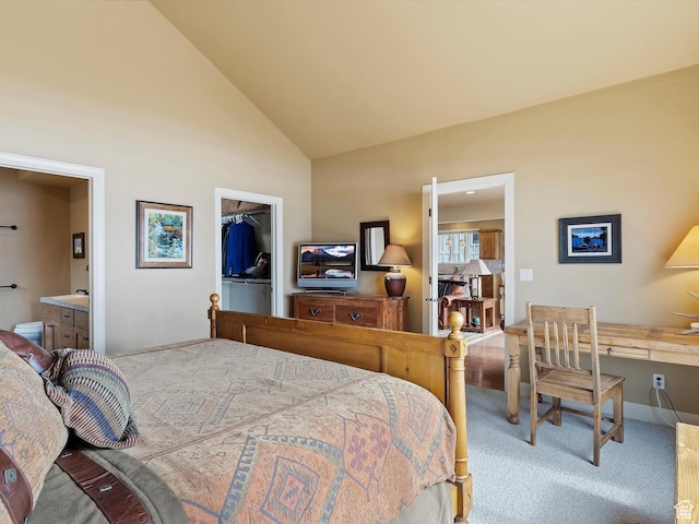 carpeted bedroom with a spacious closet, high vaulted ceiling, a closet, and ensuite bathroom