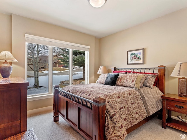 carpeted bedroom featuring baseboards