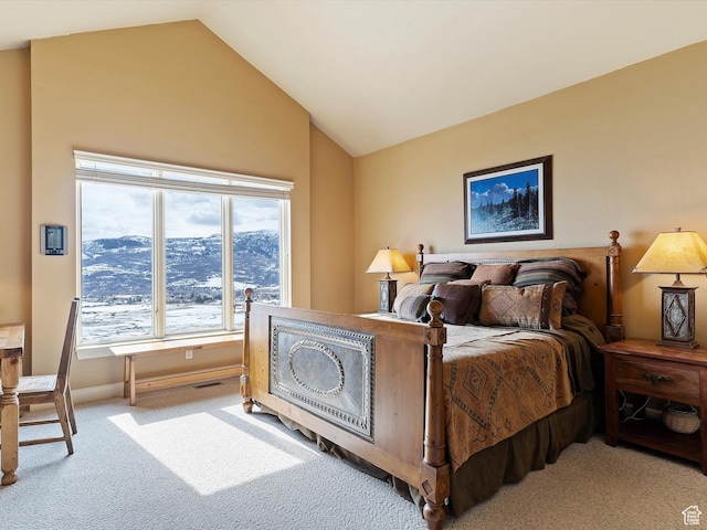 carpeted bedroom with lofted ceiling, visible vents, and baseboards