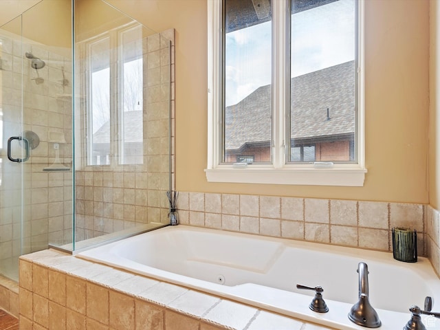 full bathroom featuring a stall shower and a garden tub