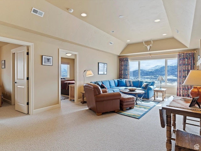 living area featuring baseboards, visible vents, vaulted ceiling, carpet flooring, and a mountain view