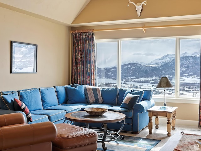 living room featuring carpet, vaulted ceiling, a mountain view, and baseboards