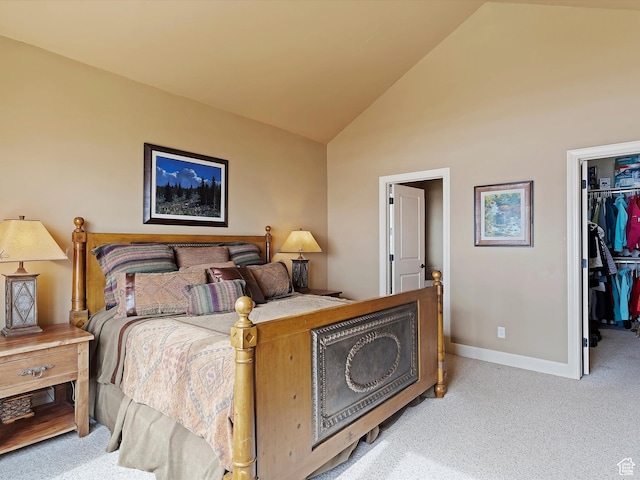 bedroom with light carpet, baseboards, a walk in closet, high vaulted ceiling, and a closet