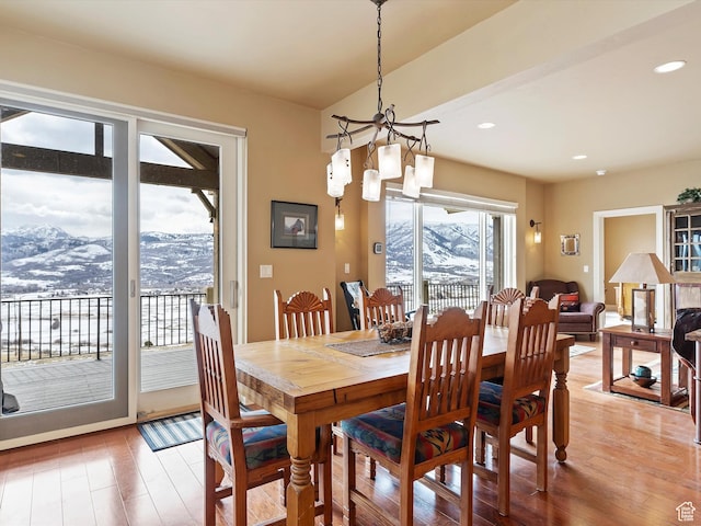 dining space featuring a notable chandelier, light wood-style flooring, a mountain view, and recessed lighting