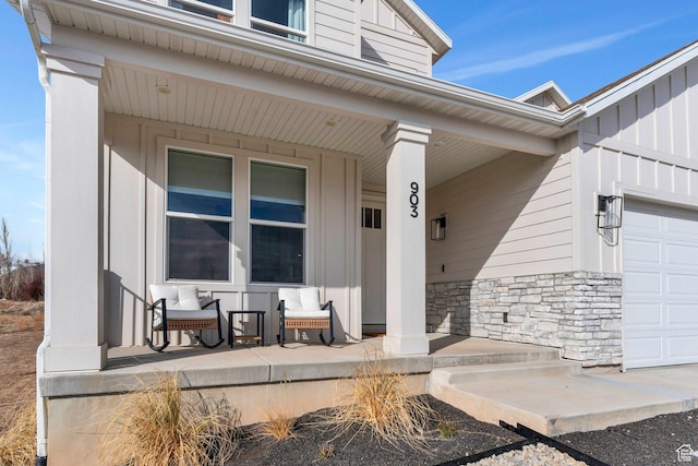 903 E 200 S, Pleasant Grove, UT 84062 - doorway to property featuring a garage, covered porch, stone siding, and board and batten siding