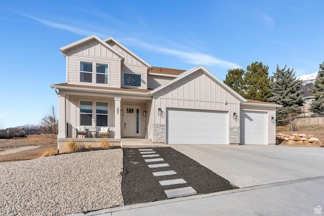 903 E 200 S, Pleasant Grove, UT 84062 - view of front of property with a garage, concrete driveway, stone siding, covered porch, and board and batten siding