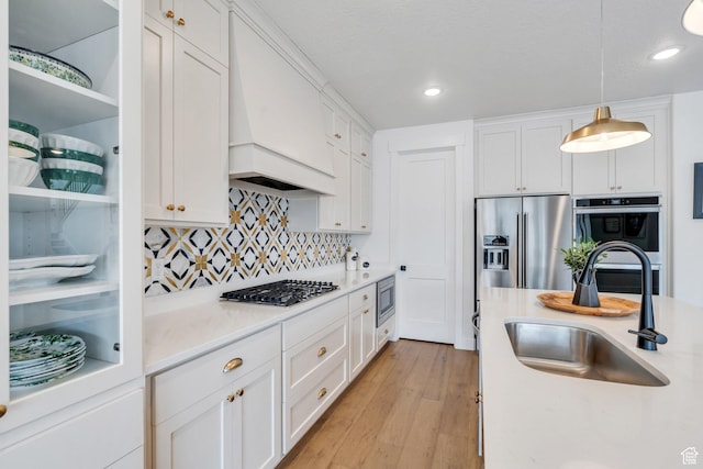 903 E 200 S, Pleasant Grove, UT 84062 - kitchen featuring stainless steel appliances, a sink, white cabinets, and custom range hood