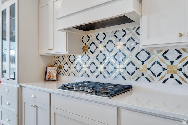 903 E 200 S, Pleasant Grove, UT 84062 - kitchen with custom range hood, stainless steel gas stovetop, backsplash, white cabinetry, and light stone countertops