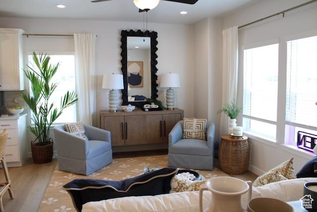 living area featuring a ceiling fan, light wood-style flooring, and recessed lighting