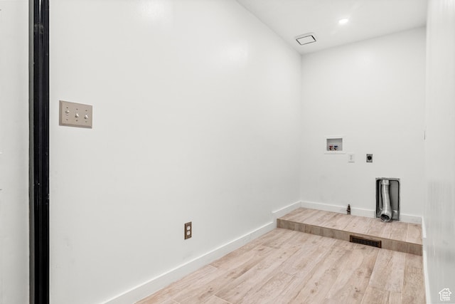 laundry room featuring hookup for a washing machine, visible vents, wood finished floors, laundry area, and baseboards