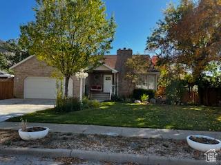 829 E 1925 N, North Ogden, UT 84414 - view of property hidden behind natural elements with an attached garage, driveway, and a front yard