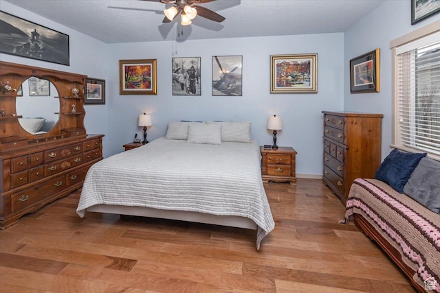 3879 S Mcgregor Ln, Saratoga Springs, UT 84045 - bedroom with a textured ceiling, baseboards, light wood-style flooring, and a ceiling fan