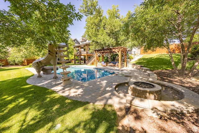 view of pool featuring a patio, a fenced backyard, a water slide, a yard, and a pergola