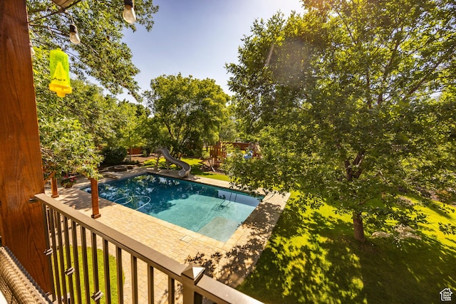 view of swimming pool with a water slide
