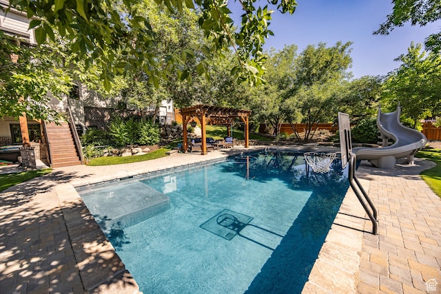 view of pool with a patio, fence, a pergola, a water slide, and stairs