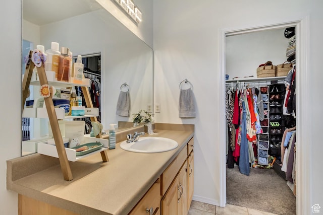 12793 S Timber Run Dr W, Riverton, UT 84096 - bathroom featuring tile patterned flooring, a walk in closet, and vanity