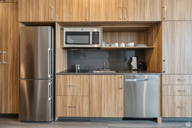 2670 W Canyons Resort Dr Unit 325, Park City, UT 84098 - kitchen featuring dark countertops, appliances with stainless steel finishes, modern cabinets, and a sink