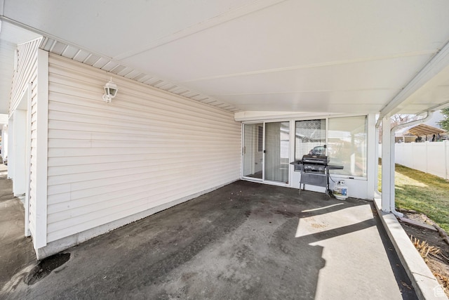 view of patio with a grill and fence