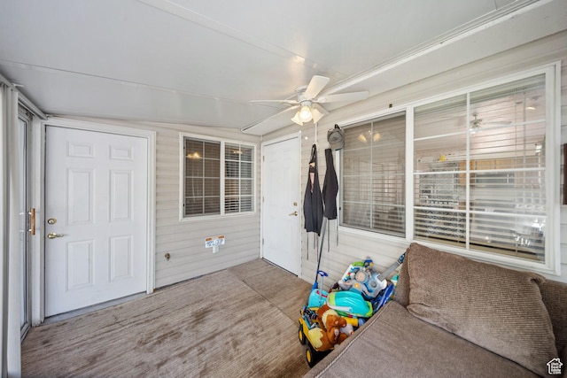 unfurnished sunroom featuring ceiling fan