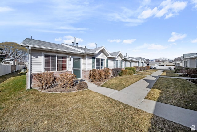 ranch-style home featuring a front yard