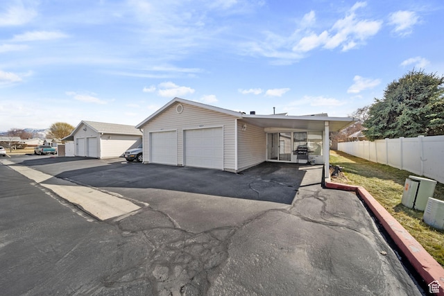 view of front of property featuring a garage and fence