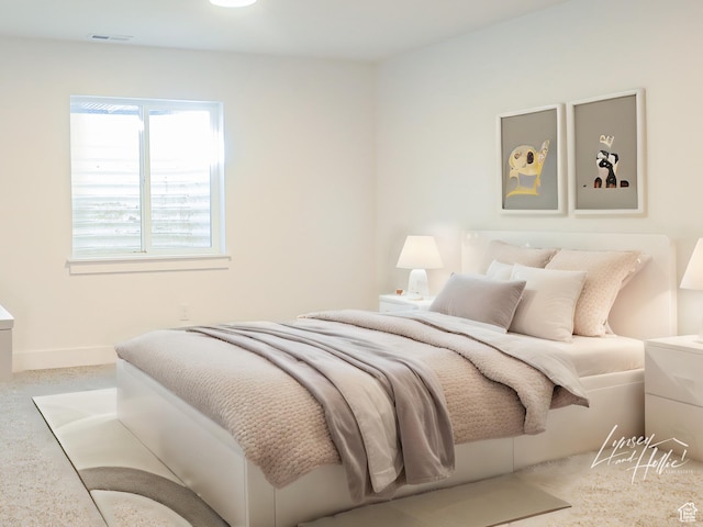 bedroom featuring visible vents and baseboards