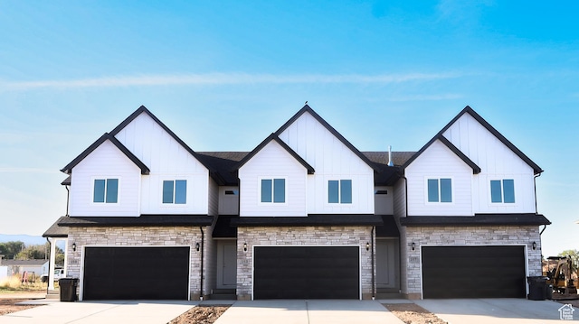 view of front of home featuring driveway, an attached garage, and board and batten siding
