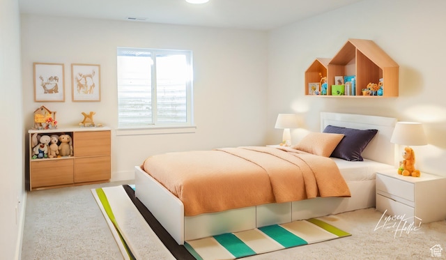 bedroom with visible vents and carpet flooring