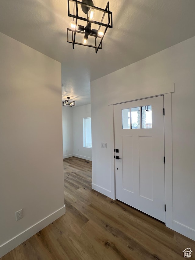 entryway with wood finished floors and baseboards