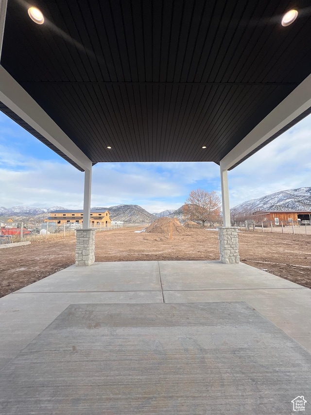 view of patio featuring fence and a mountain view
