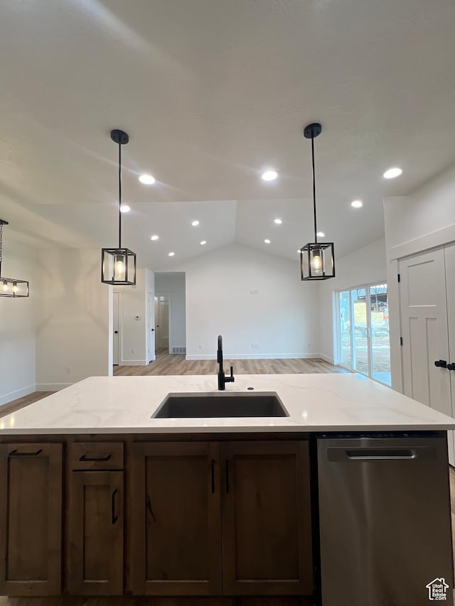 kitchen featuring a sink, dark brown cabinetry, dishwasher, and open floor plan