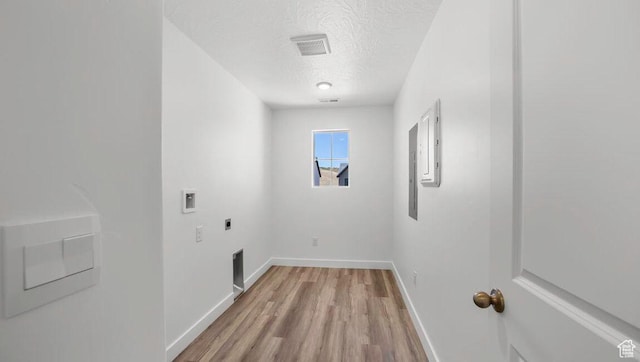 1726 S Wolverine Way Unit 174, Washington, UT 84780 - laundry area featuring hookup for an electric dryer, light wood-style floors, laundry area, hookup for a washing machine, and a textured ceiling