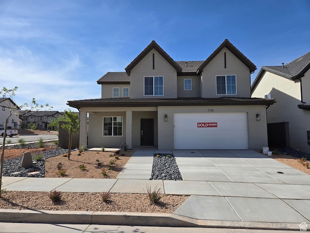 1726 S Wolverine Way Unit 174, Washington, UT 84780 - traditional-style house with an attached garage, driveway, stucco siding, and covered porch