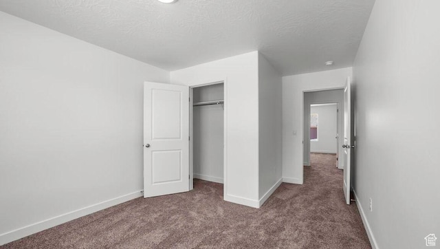 1726 S Wolverine Way Unit 174, Washington, UT 84780 - unfurnished bedroom with baseboards, a textured ceiling, a closet, and carpet