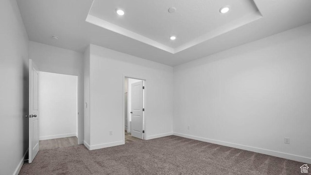 1726 S Wolverine Way Unit 174, Washington, UT 84780 - unfurnished bedroom featuring recessed lighting, baseboards, carpet floors, and a tray ceiling