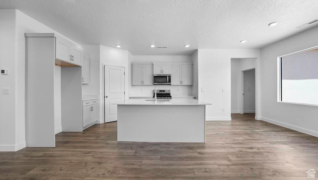 1726 S Wolverine Way Unit 174, Washington, UT 84780 - kitchen with recessed lighting, dark wood-type flooring, light countertops, a textured ceiling, and appliances with stainless steel finishes